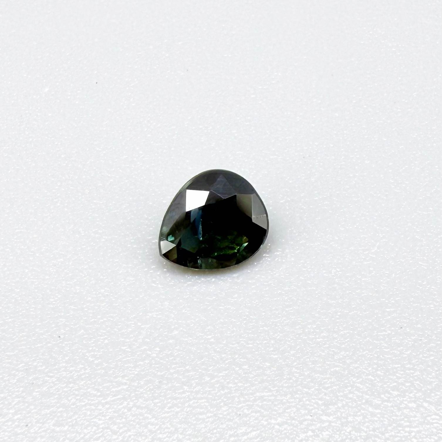 0.62 ct teal Laos sapphire in oval cut, heated and eye-clean with captivating blue-green color.