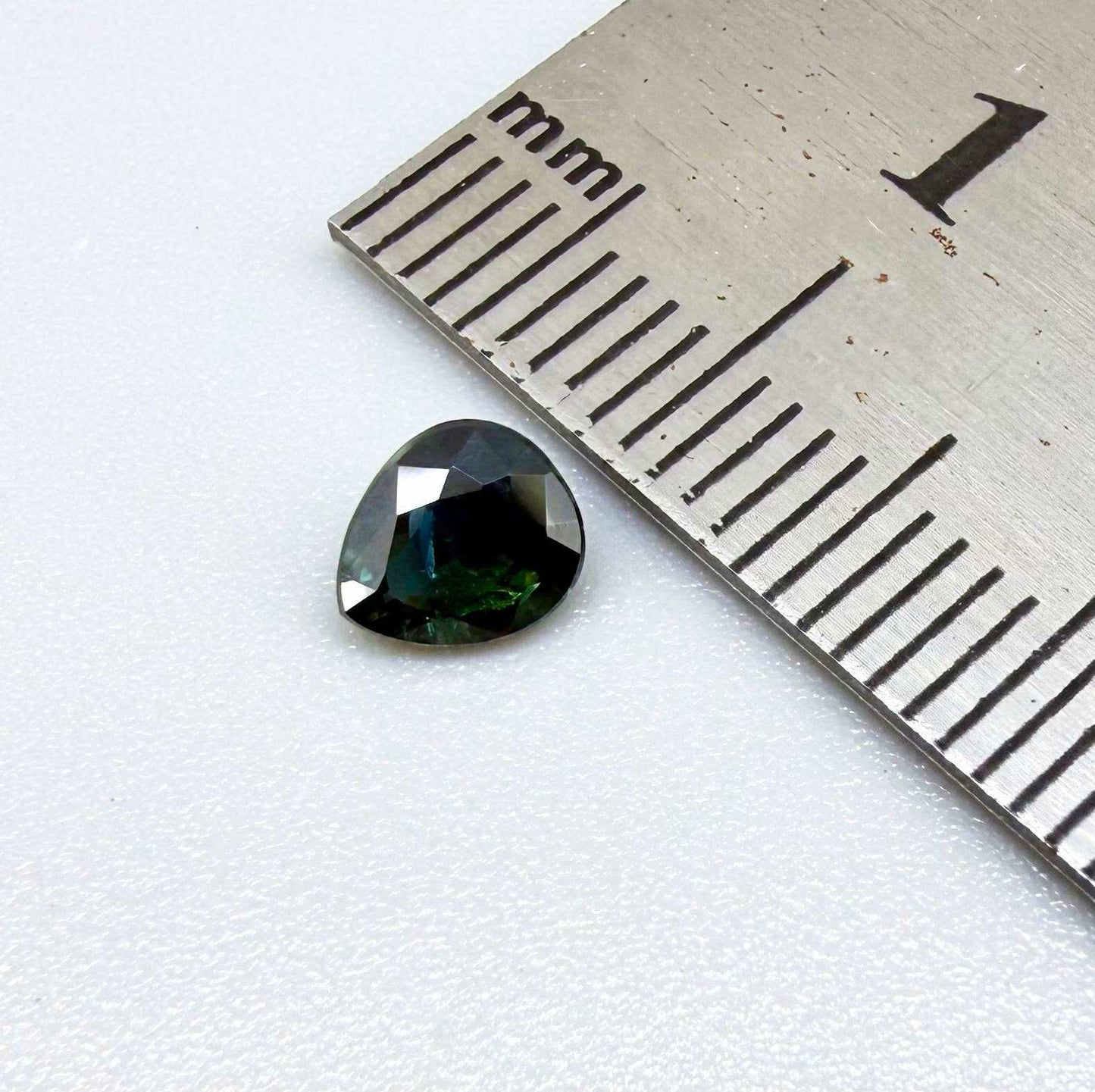 0.62 ct teal Laos sapphire in oval cut, heated and eye-clean with captivating blue-green color.