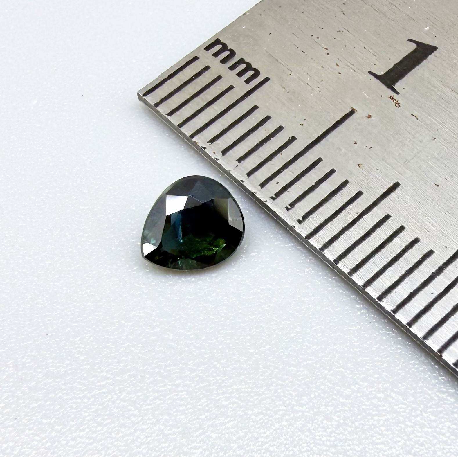 0.62 ct teal Laos sapphire in oval cut, heated and eye-clean with captivating blue-green color.