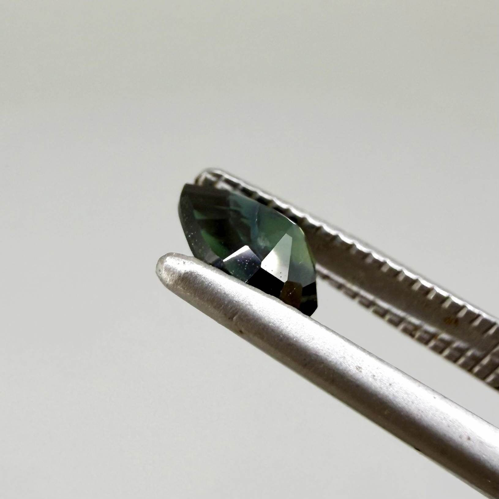 0.62 ct teal Laos sapphire in oval cut, heated and eye-clean with captivating blue-green color.