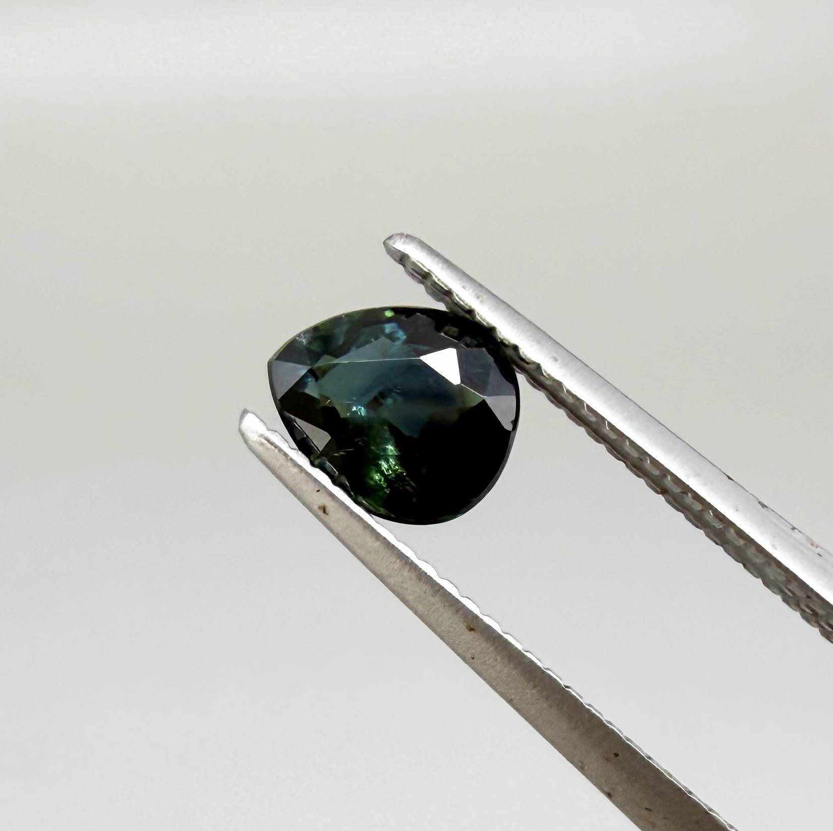 0.62 ct teal Laos sapphire in oval cut, heated and eye-clean with captivating blue-green color.