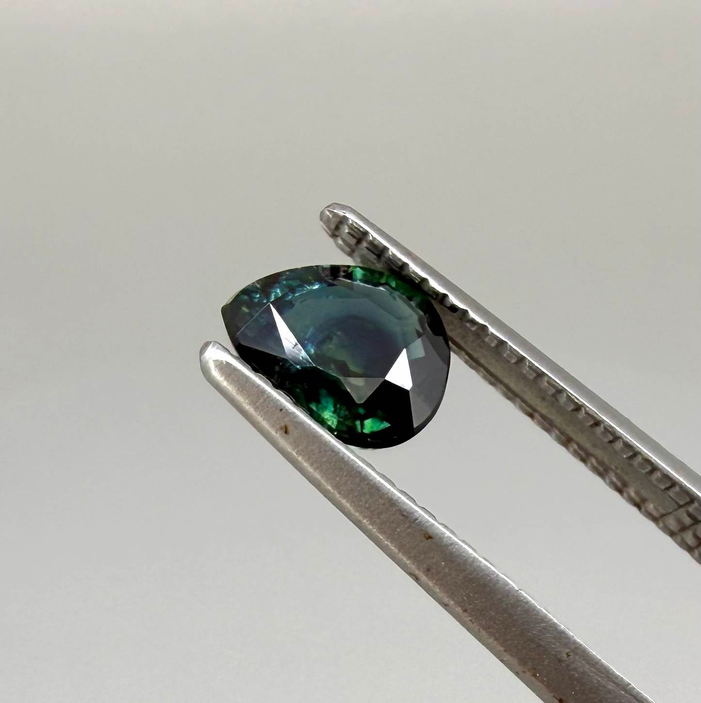 0.62 ct teal Laos sapphire in oval cut, heated and eye-clean with captivating blue-green color.