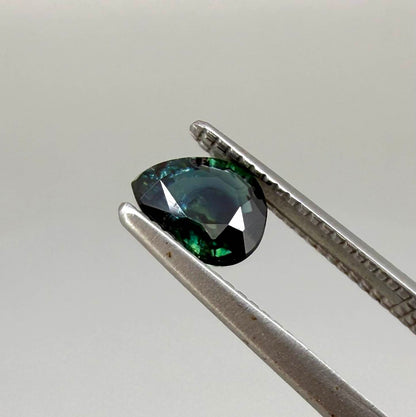 0.62 ct teal Laos sapphire in oval cut, heated and eye-clean with captivating blue-green color.