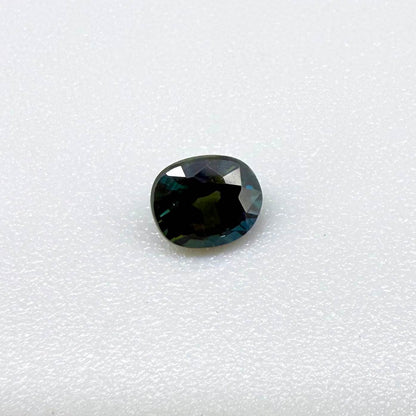 0.66 ct teal Laos sapphire in oval cut, heated and eye-clean with vivid blue-green color.