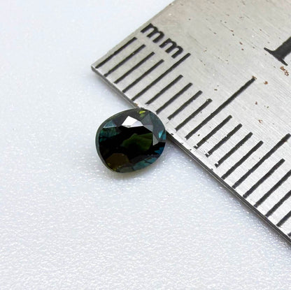 0.66 ct teal Laos sapphire in oval cut, heated and eye-clean with vivid blue-green color.