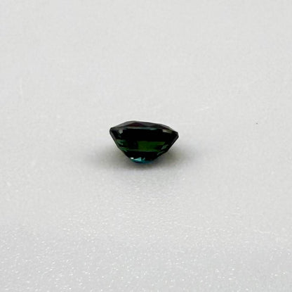 0.56 ct teal Laos sapphire in oval cut, heated and eye-clean with captivating blue-green color.
