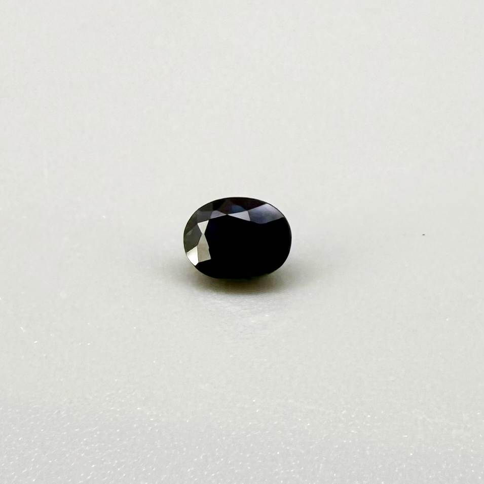 0.56 ct teal Laos sapphire in oval cut, heated and eye-clean with captivating blue-green color.