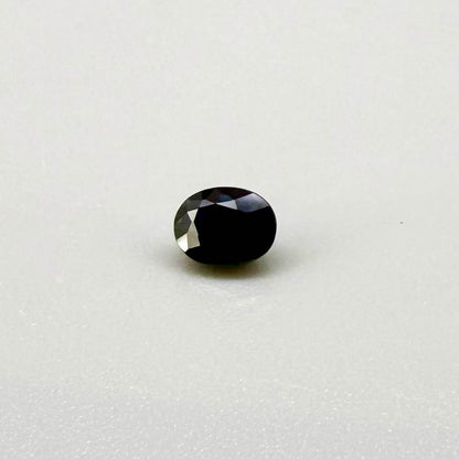 0.56 ct teal Laos sapphire in oval cut, heated and eye-clean with captivating blue-green color.