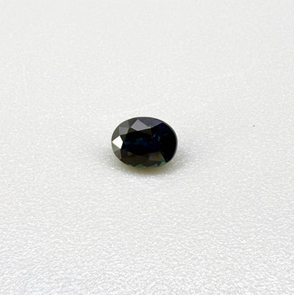 0.56 ct teal Laos sapphire in oval cut, heated and eye-clean with captivating blue-green color.