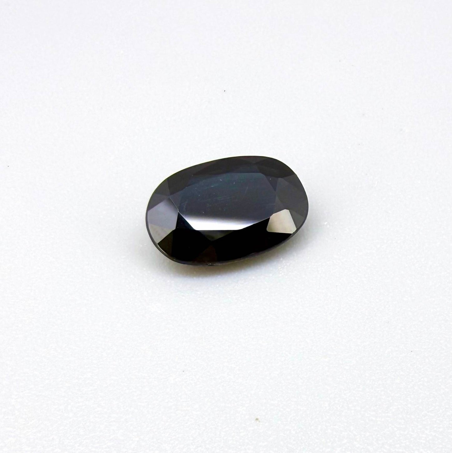 Natural heated deep teal Laos sapphire, 3.18 ct oval with eye-clean clarity and vivid blue-green flashes.