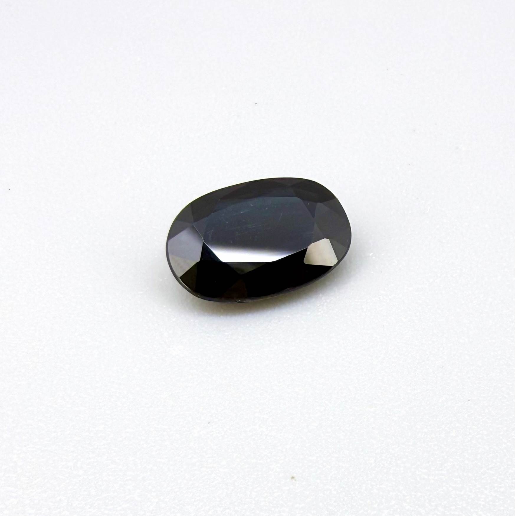 Natural heated deep teal Laos sapphire, 3.18 ct oval with eye-clean clarity and vivid blue-green flashes.