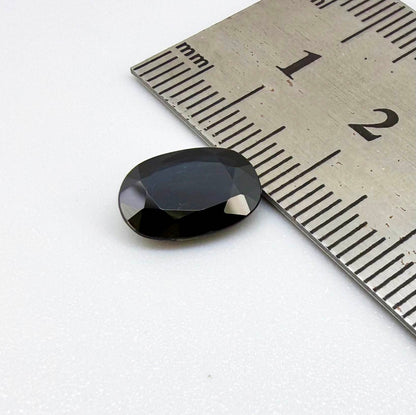 Natural heated deep teal Laos sapphire, 3.18 ct oval with eye-clean clarity and vivid blue-green flashes.