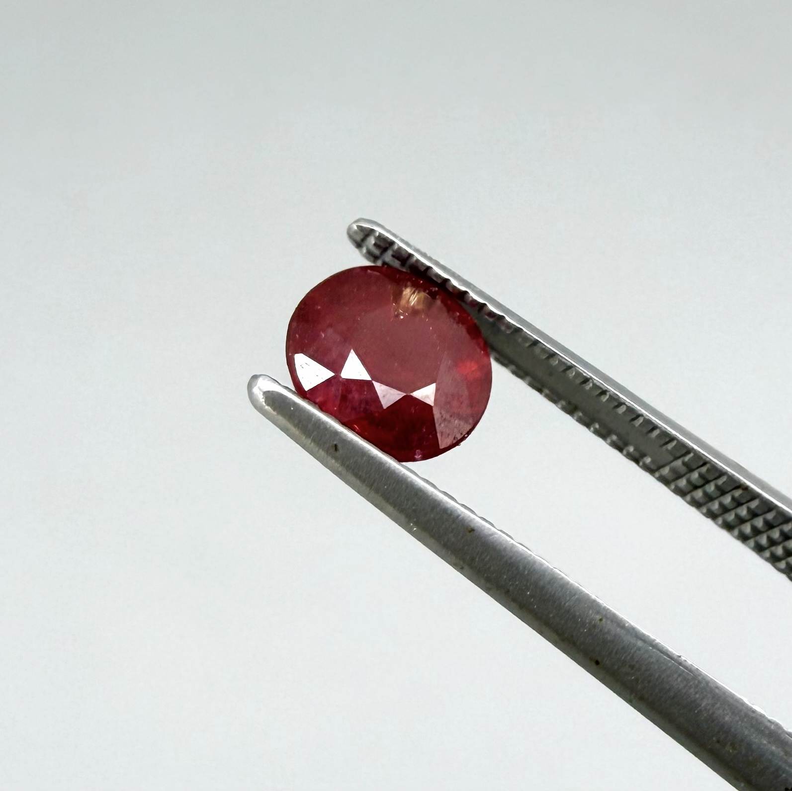 Natural Mozambique ruby pair in round cut, 2.20 ct total weight, enhanced and precisely matched.
