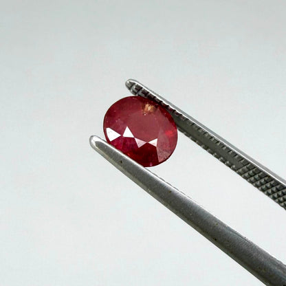 Natural Mozambique ruby pair in round cut, 2.20 ct total weight, enhanced and precisely matched.