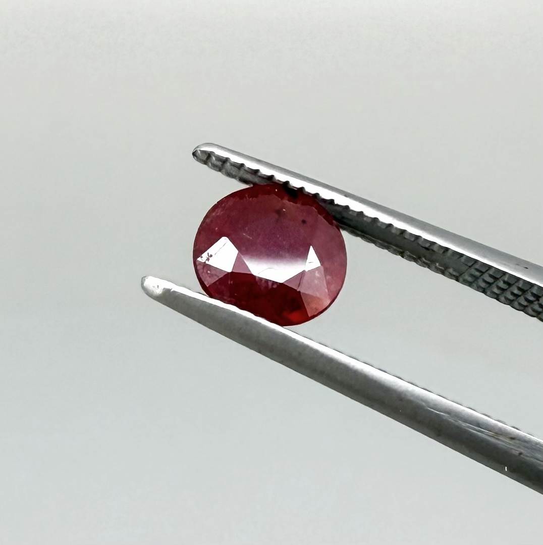 Natural Mozambique ruby pair in round cut, 2.20 ct total weight, enhanced and precisely matched.