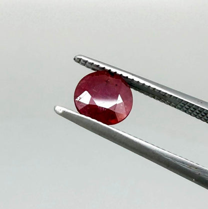 Natural Mozambique ruby pair in round cut, 2.20 ct total weight, enhanced and precisely matched.