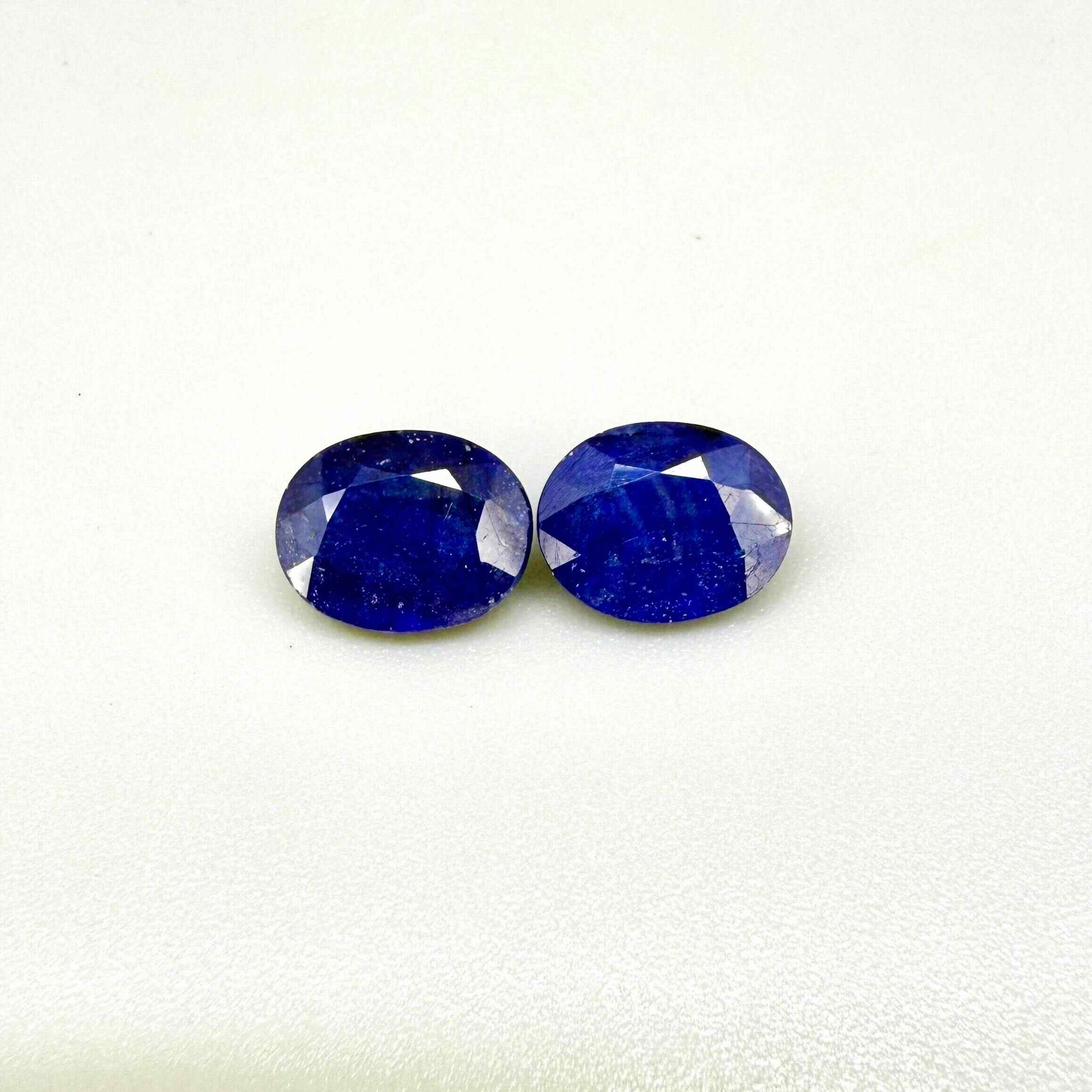 Large natural enhanced deep blue sapphire matching pair 7.71 ct oval faceted gemstones for earrings