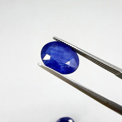 Large natural enhanced deep blue sapphire matching pair 7.71 ct oval faceted gemstones for earrings