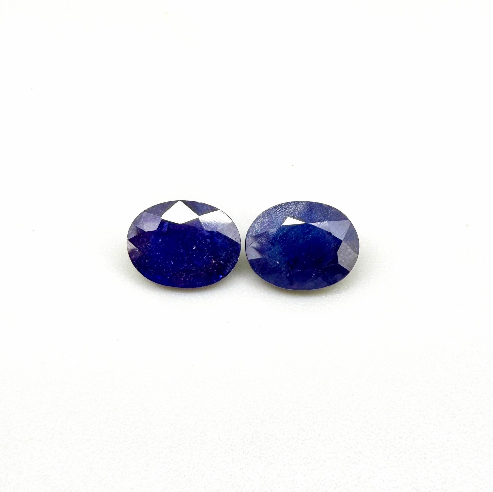 10.36 ct natural enhanced deep blue sapphire matching pair with oval faceted cut for custom earrings