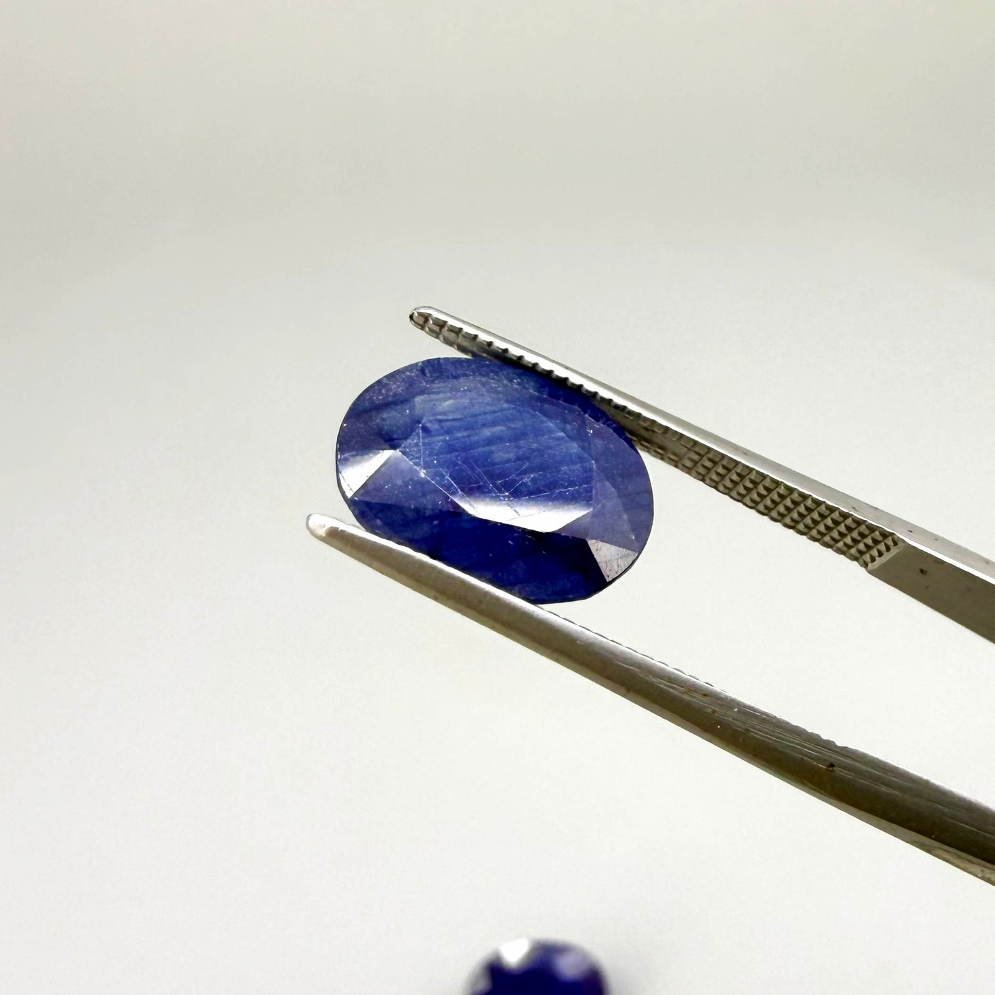 10.36 ct natural enhanced deep blue sapphire matching pair with oval faceted cut for custom earrings