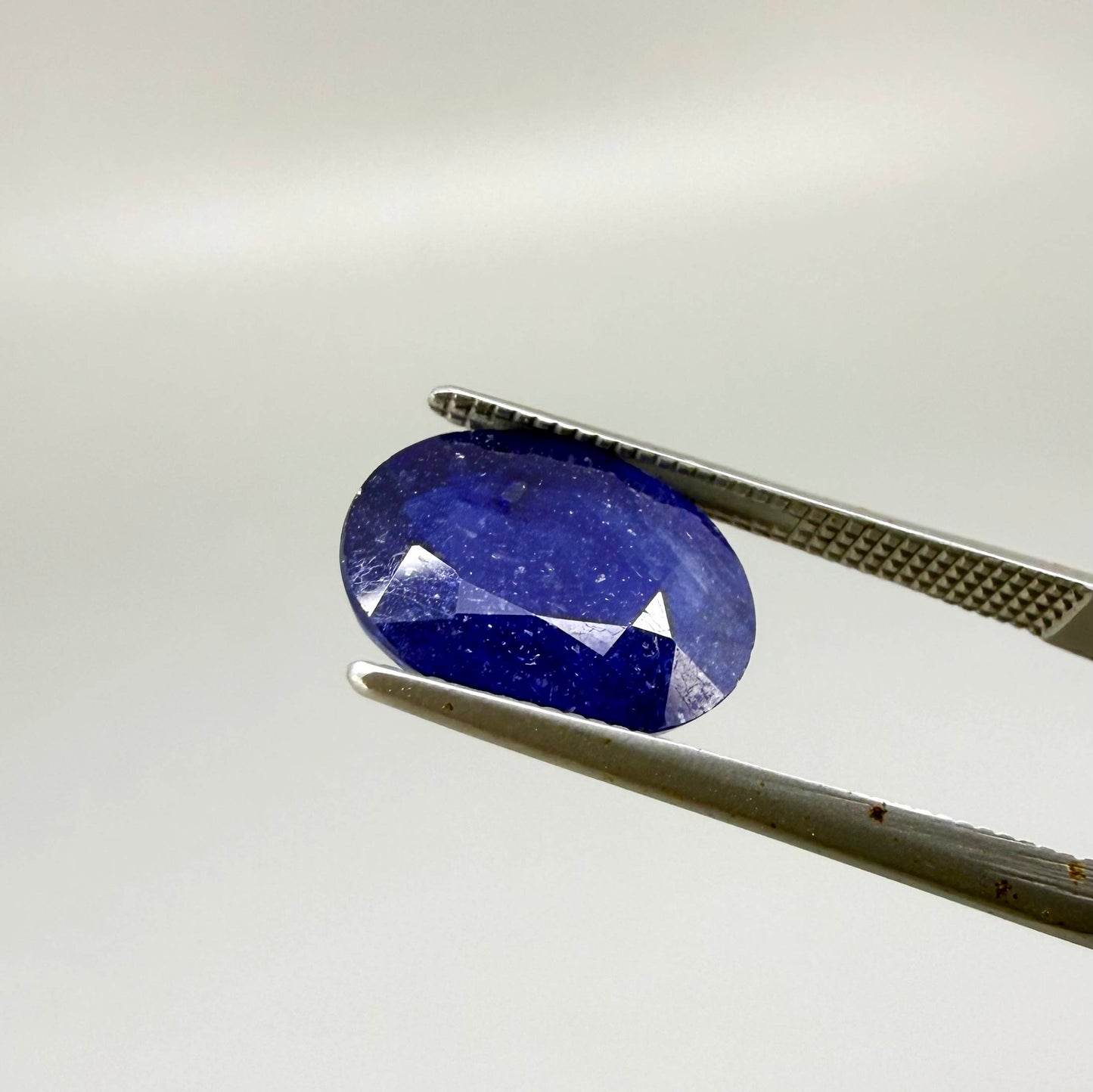 10.36 ct natural enhanced deep blue sapphire matching pair with oval faceted cut for custom earrings