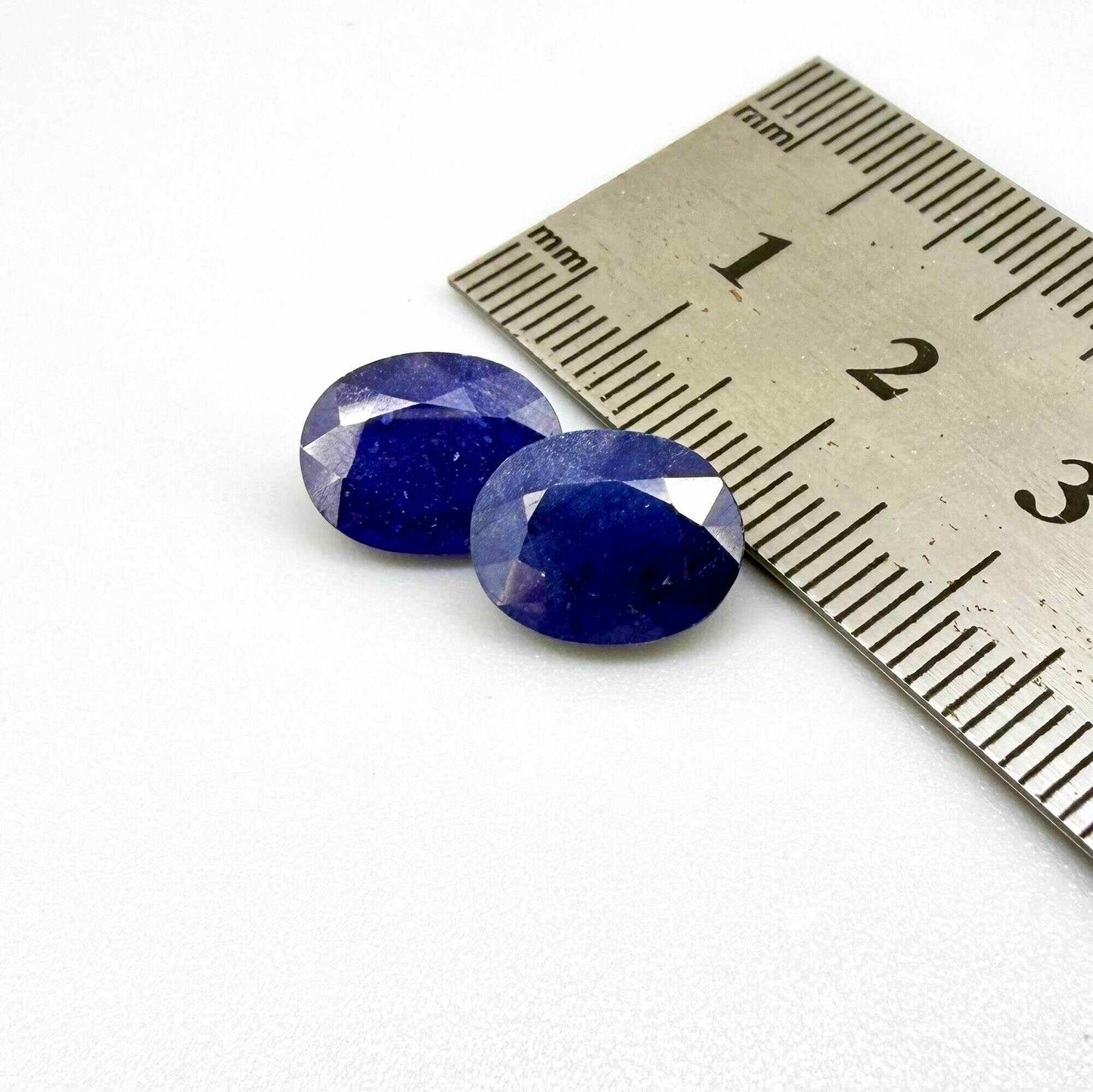 10.36 ct natural enhanced deep blue sapphire matching pair with oval faceted cut for custom earrings