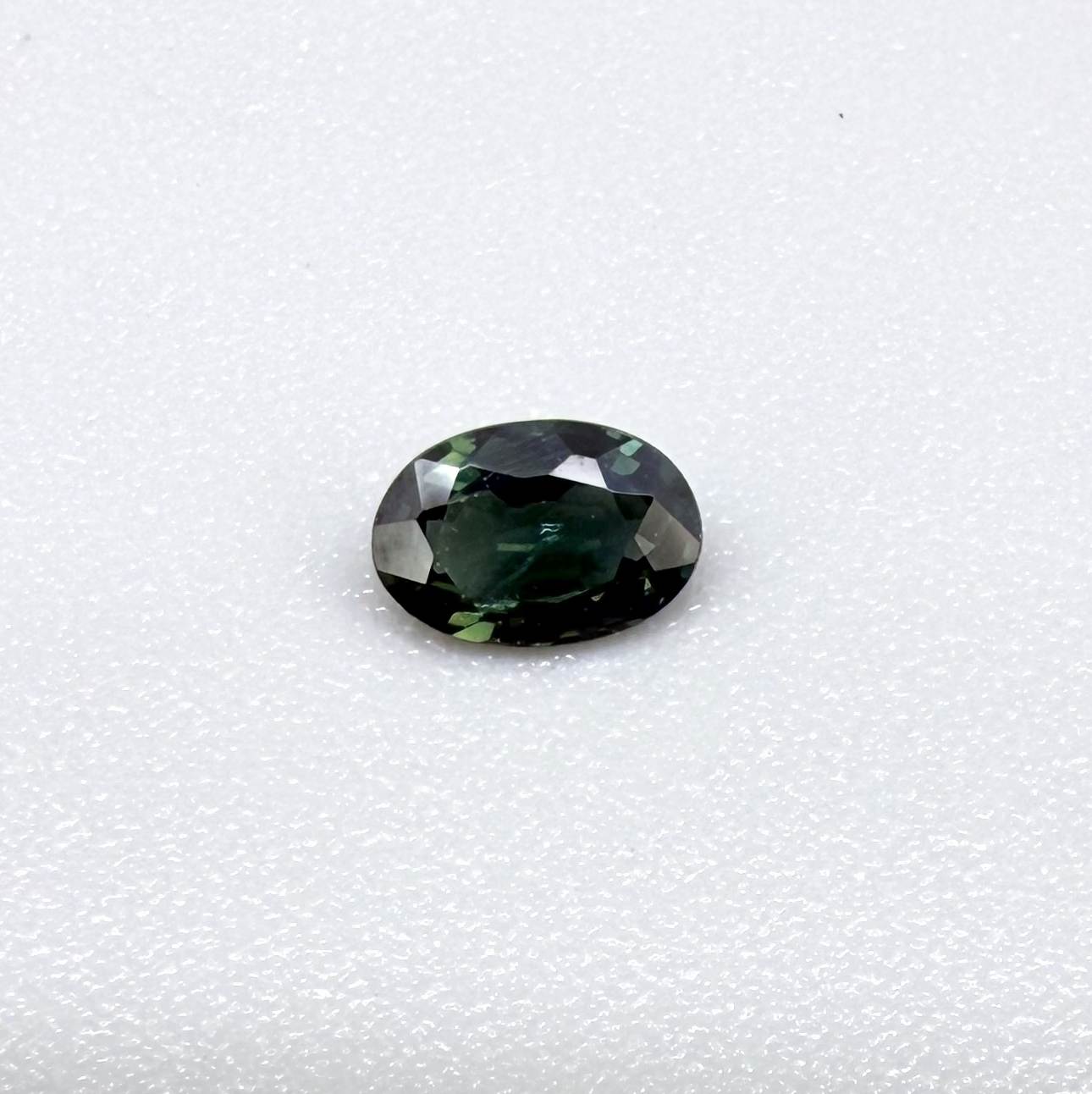 0.28 ct natural heated teal Laos sapphire with oval faceted cut and exceptional clarity