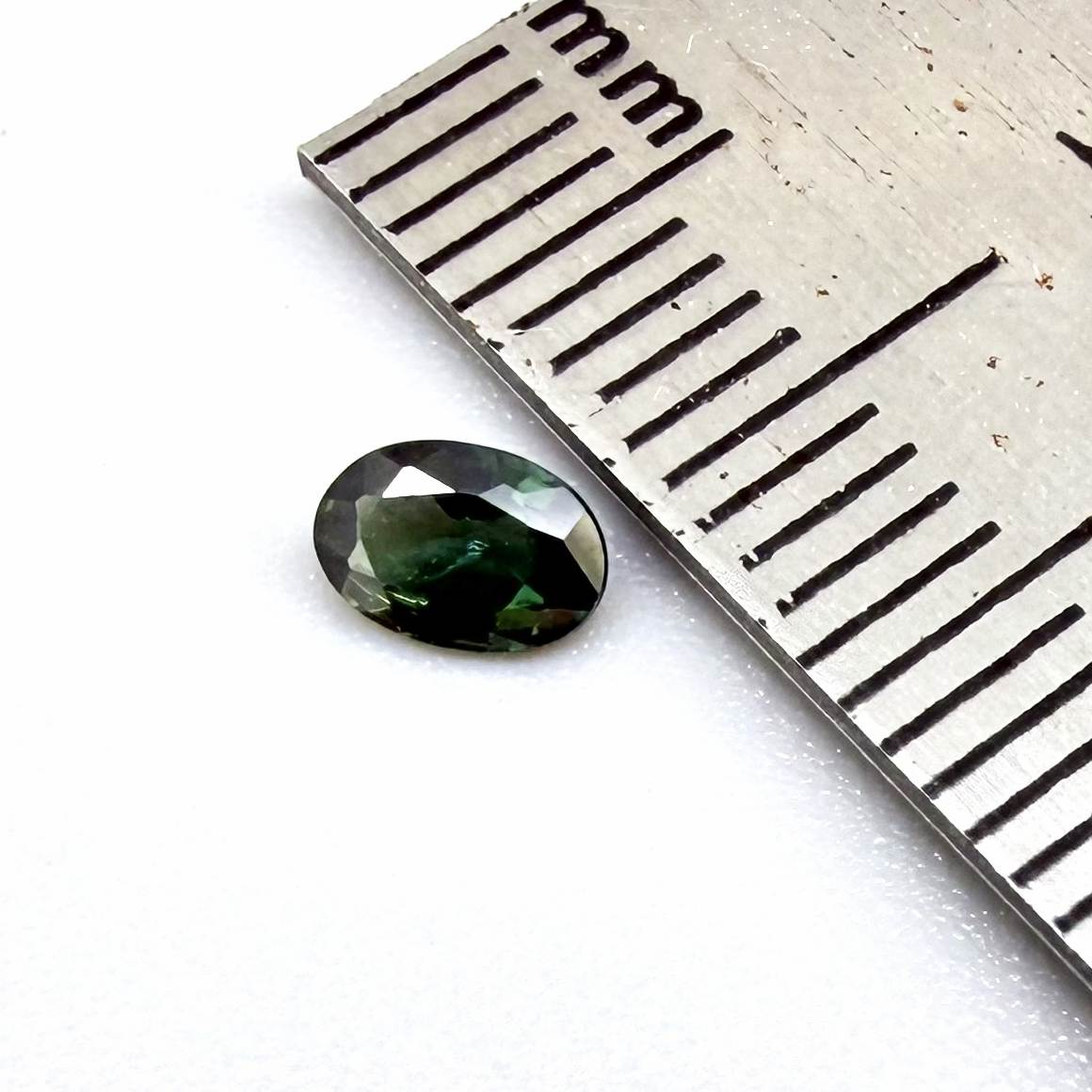 0.28 ct natural heated teal Laos sapphire with oval faceted cut and exceptional clarity