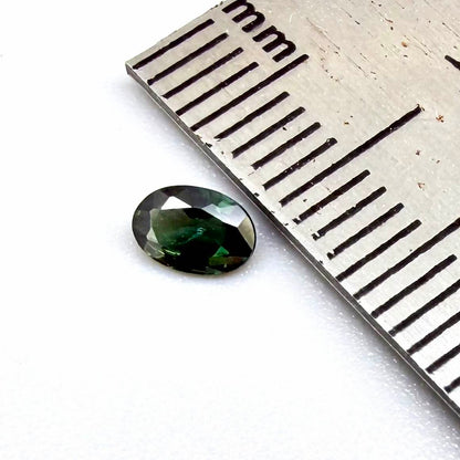 0.28 ct natural heated teal Laos sapphire with oval faceted cut and exceptional clarity