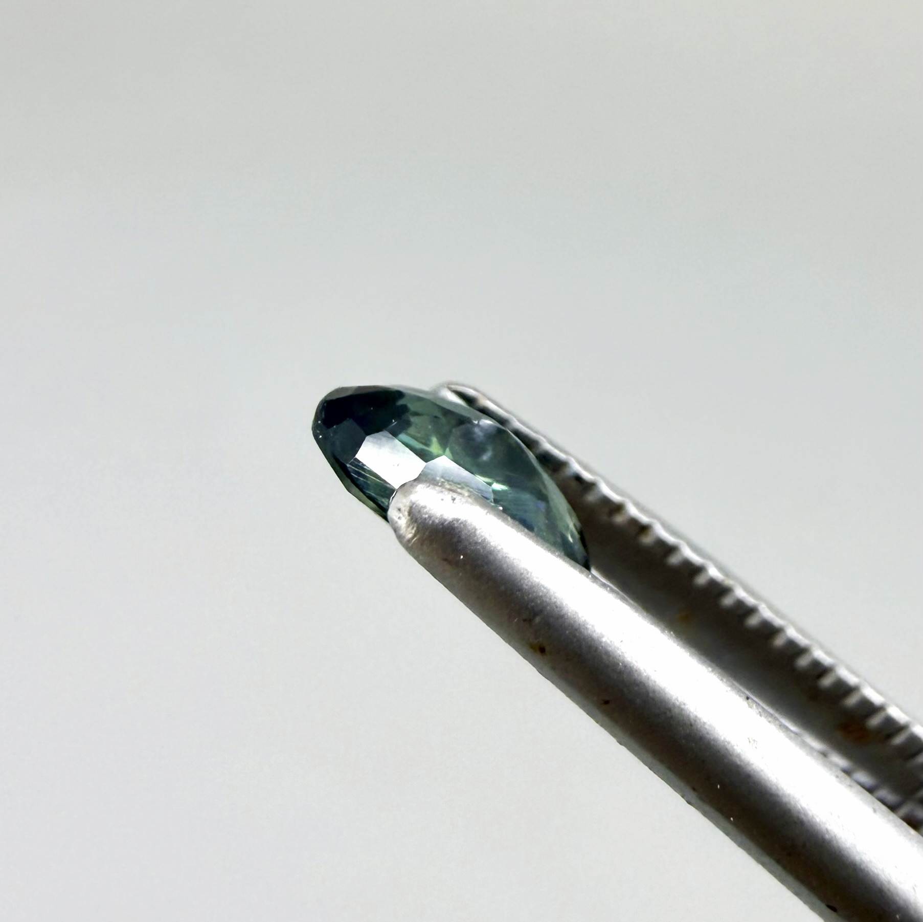 0.28 ct natural heated teal Laos sapphire with oval faceted cut and exceptional clarity