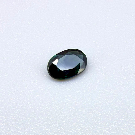 0.28 ct natural heated teal Laos sapphire with oval faceted cut and eye-clean clarity