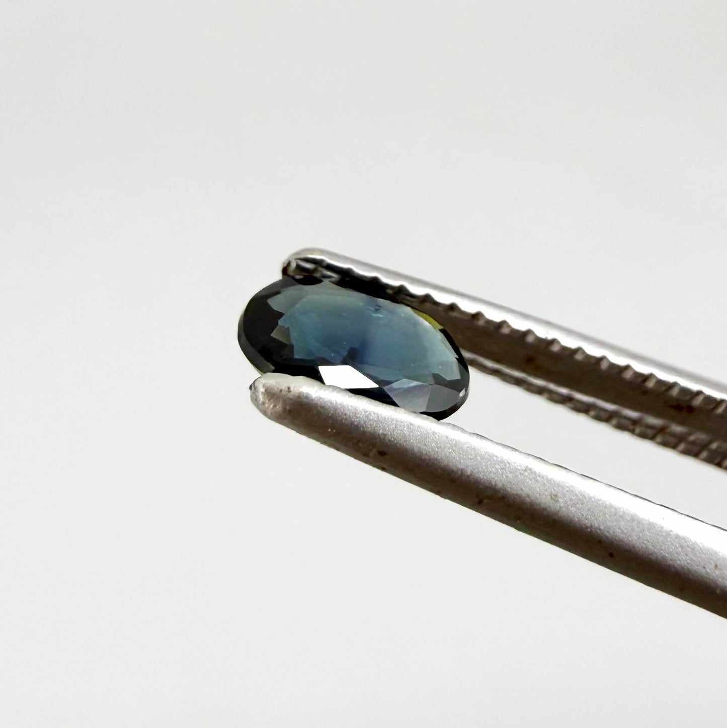 0.28 ct natural heated teal Laos sapphire with oval faceted cut and eye-clean clarity