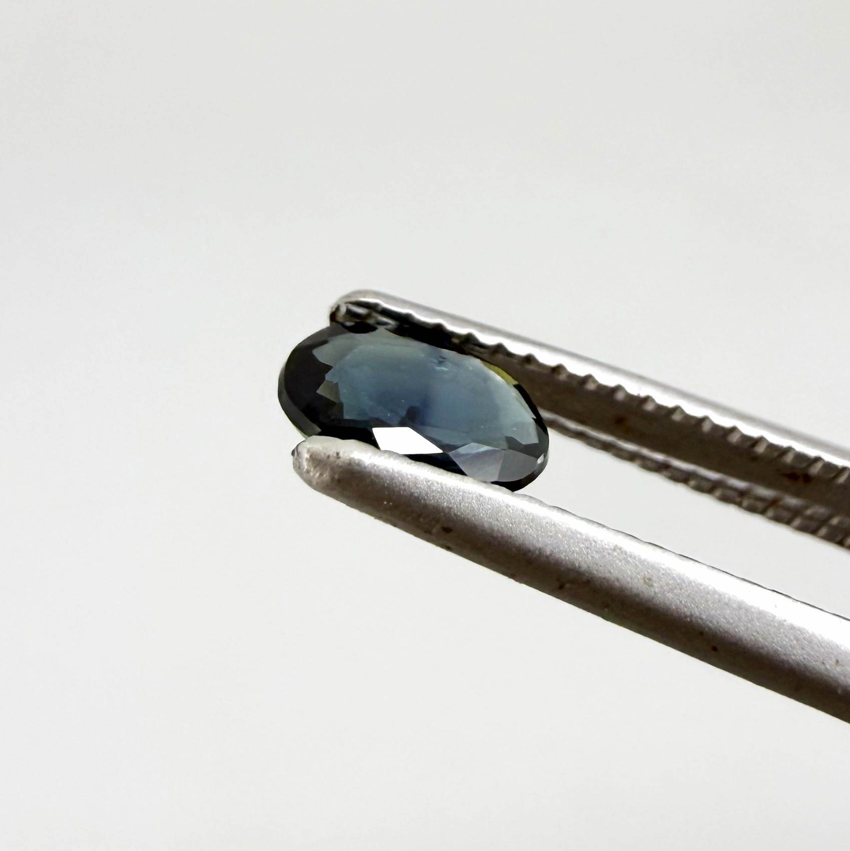 0.28 ct natural heated teal Laos sapphire with oval faceted cut and eye-clean clarity