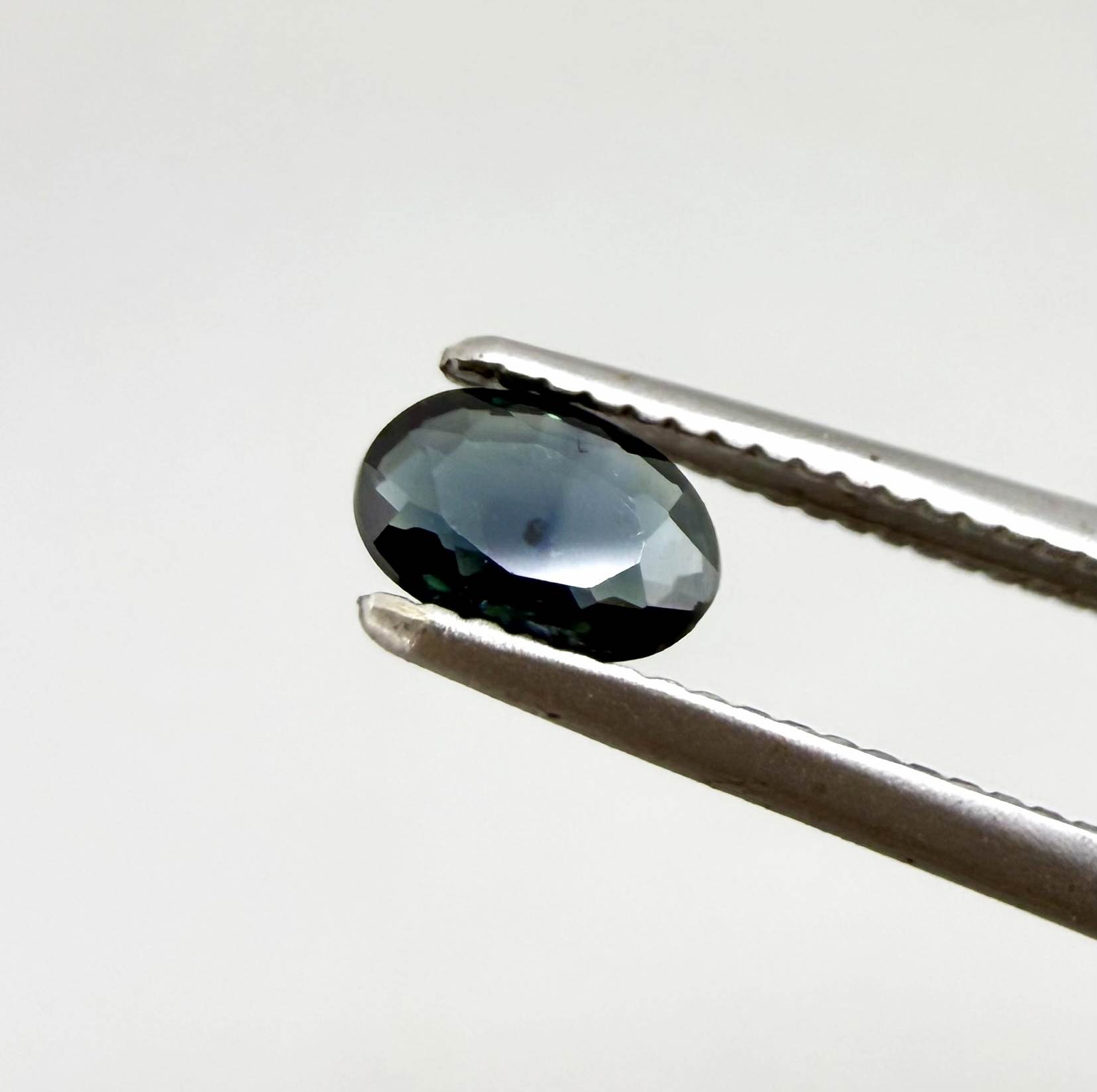 0.28 ct natural heated teal Laos sapphire with oval faceted cut and eye-clean clarity