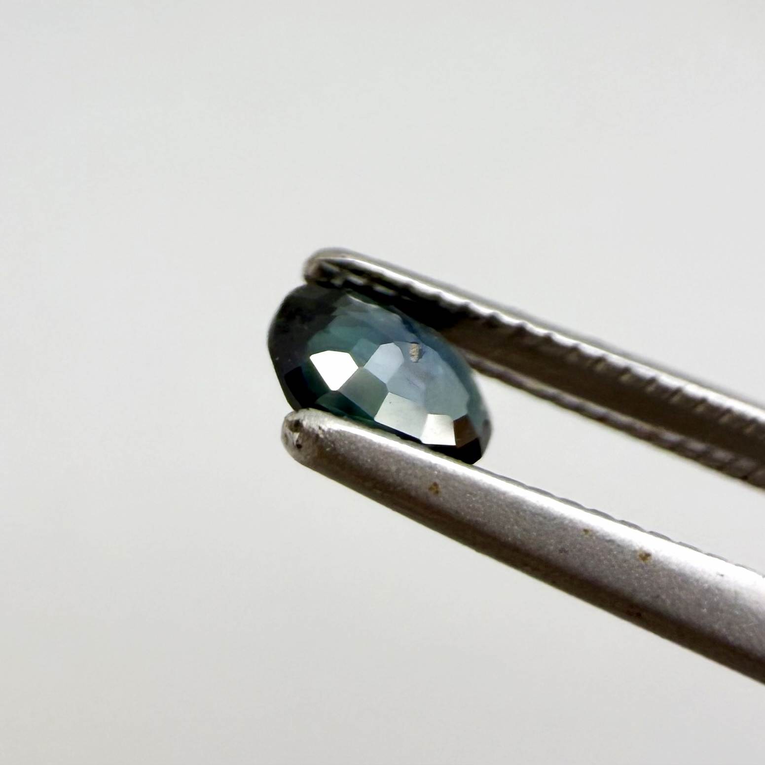 0.28 ct natural heated teal Laos sapphire with oval faceted cut and eye-clean clarity