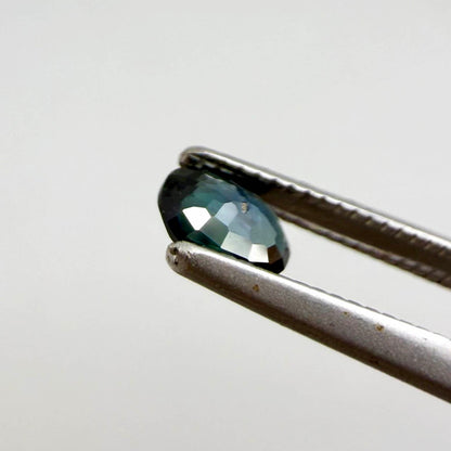 0.28 ct natural heated teal Laos sapphire with oval faceted cut and eye-clean clarity
