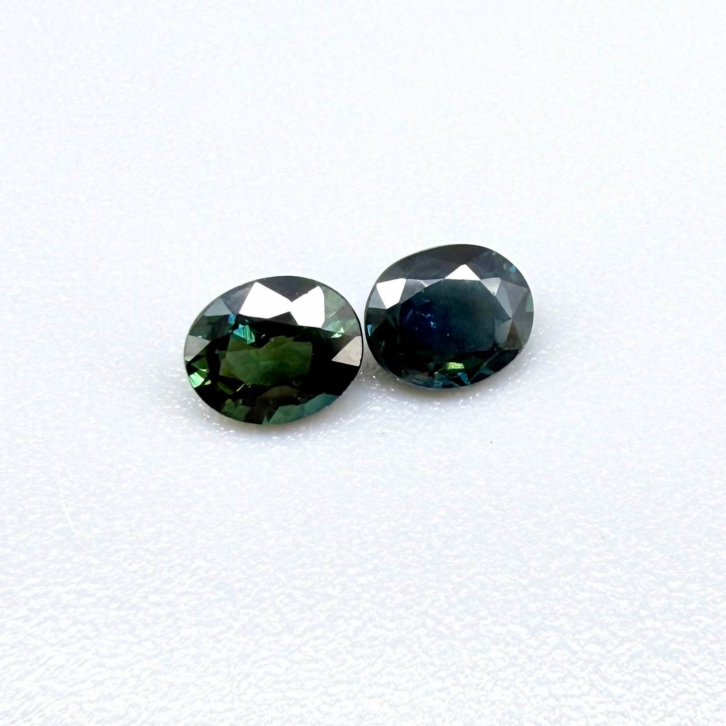 0.92 ct natural heated teal Laos sapphire matching pair with oval faceted cut for custom earrings