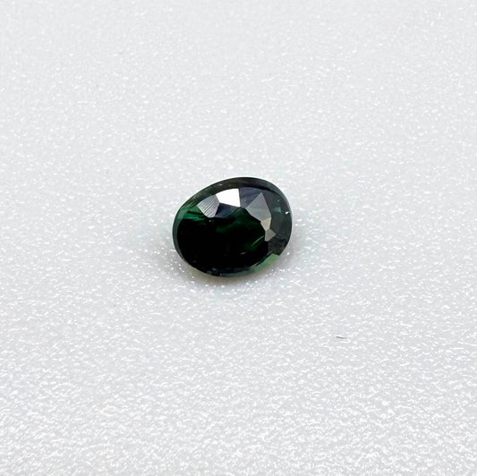 0.36 ct natural heated teal Laos sapphire with oval faceted cut and excellent clarity