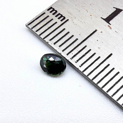 0.36 ct natural heated teal Laos sapphire with oval faceted cut and excellent clarity