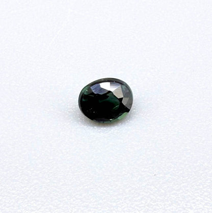 0.36 ct natural heated teal Laos sapphire with oval faceted cut and excellent clarity
