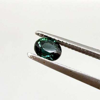 0.36 ct natural heated teal Laos sapphire with oval faceted cut and excellent clarity