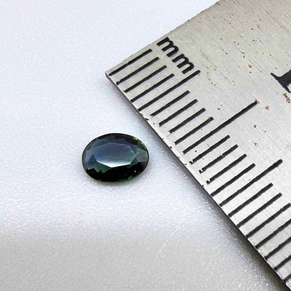 0.28 ct natural parti teal Laos sapphire with oval faceted cut and blue green colour zoning
