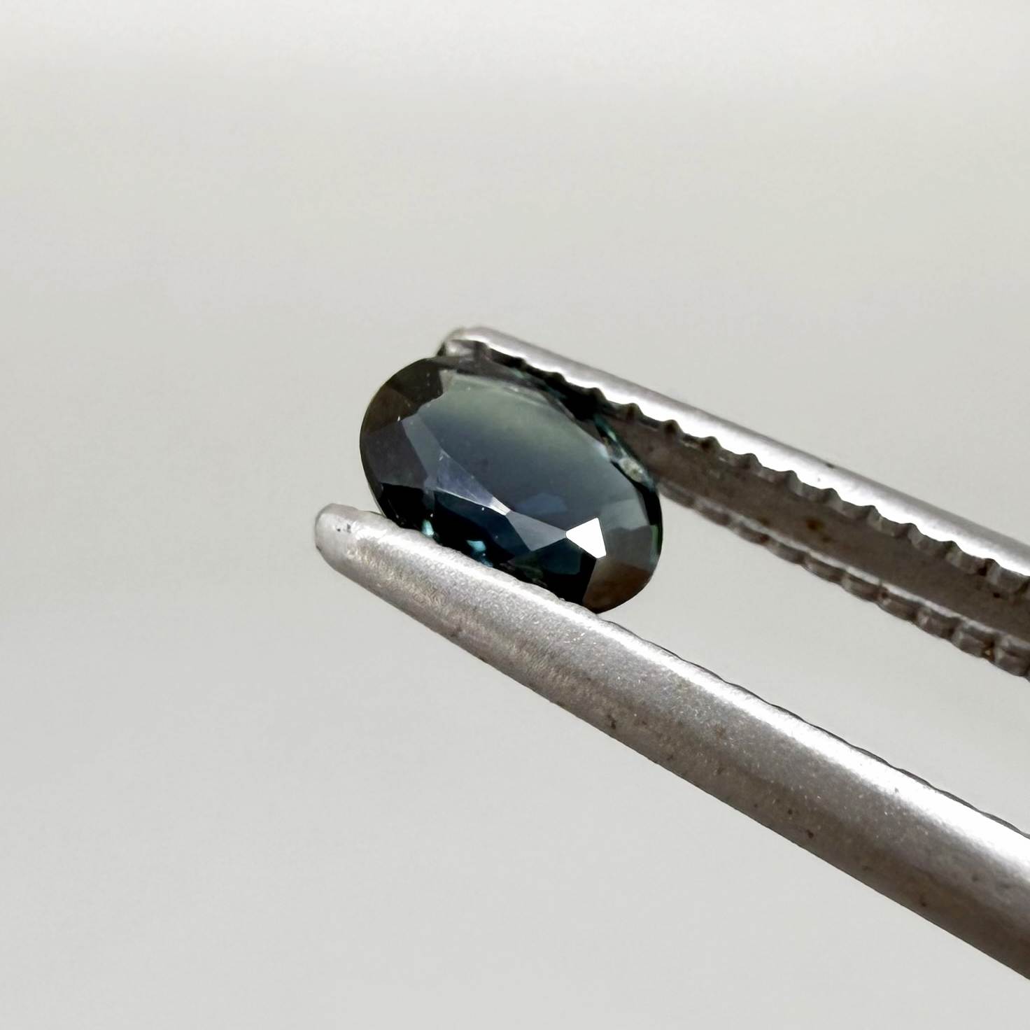 0.32 ct natural deep teal Laos sapphire with oval faceted cut and rich blue green colour