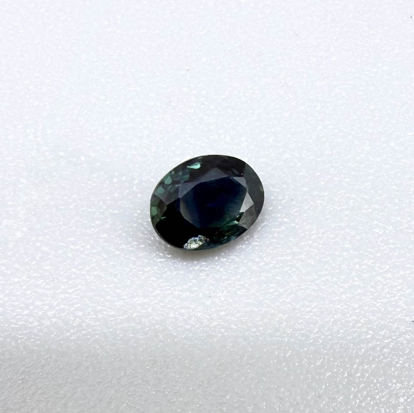 0.32 ct natural deep teal Laos sapphire with oval faceted cut and rich blue green colour