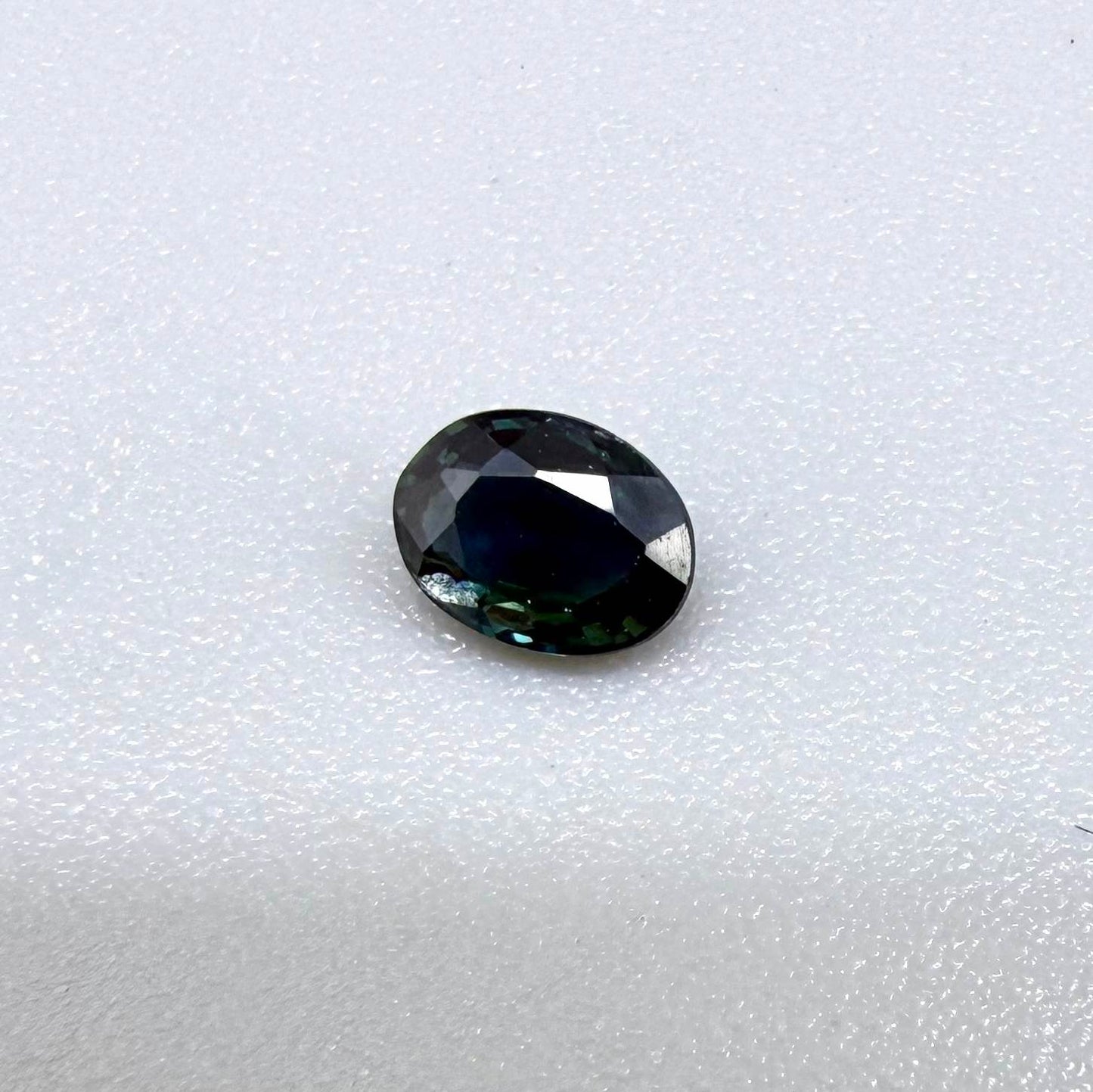 0.32 ct natural deep teal Laos sapphire with oval faceted cut and rich blue green colour