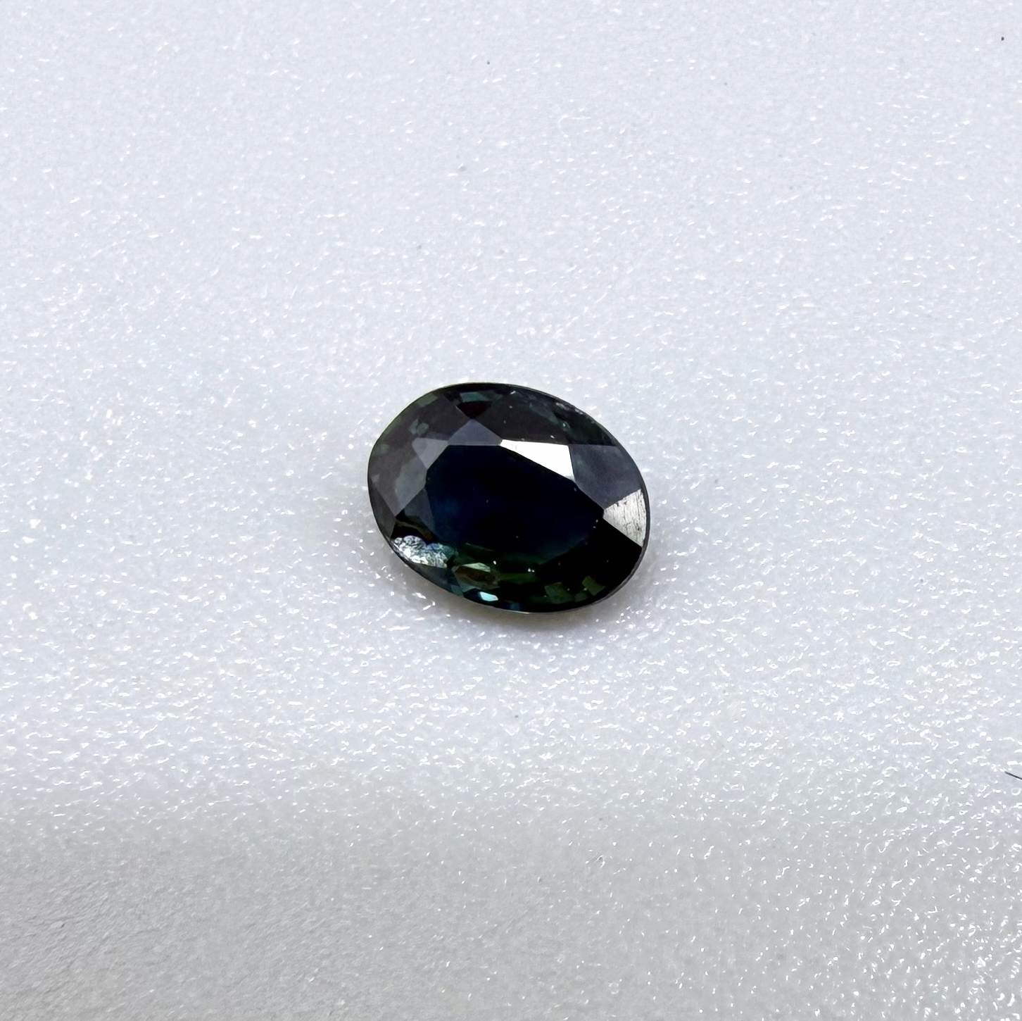 0.32 ct natural deep teal Laos sapphire with oval faceted cut and rich blue green colour