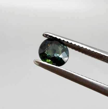 0.32 ct natural teal Laos sapphire with oval-cushion faceted cut and vibrant blue green colour