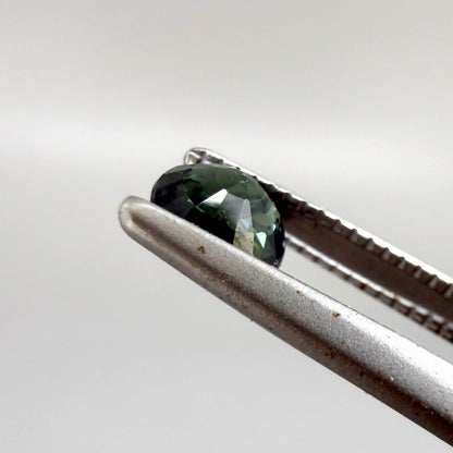 0.32 ct natural teal Laos sapphire with oval-cushion faceted cut and vibrant blue green colour