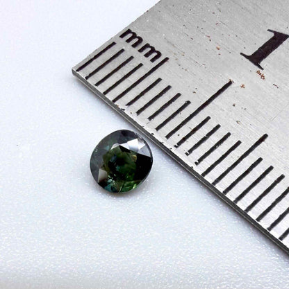 0.32 ct natural teal Laos sapphire with oval-cushion faceted cut and vibrant blue green colour