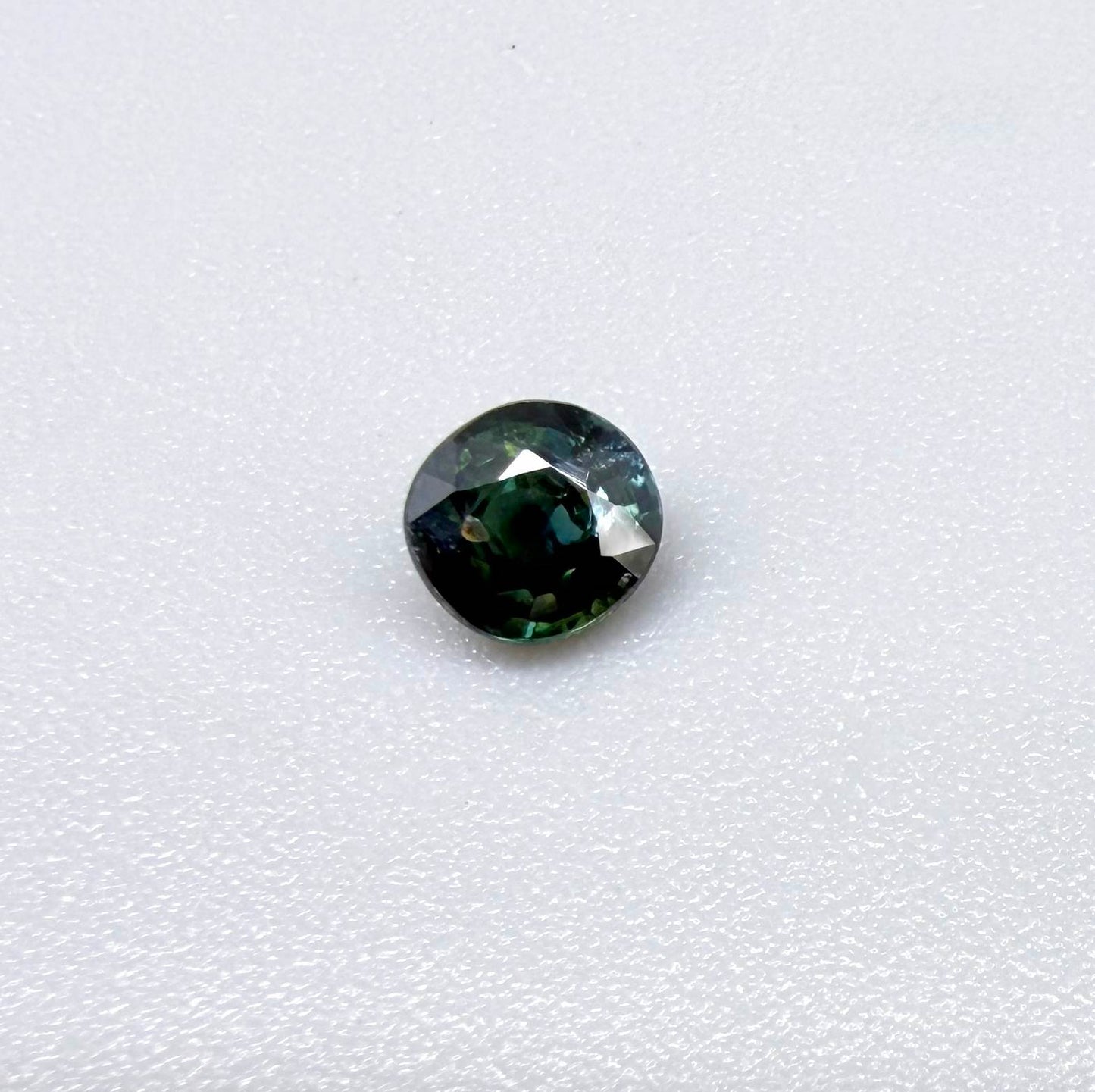 0.32 ct natural teal Laos sapphire with oval-cushion faceted cut and vibrant blue green colour